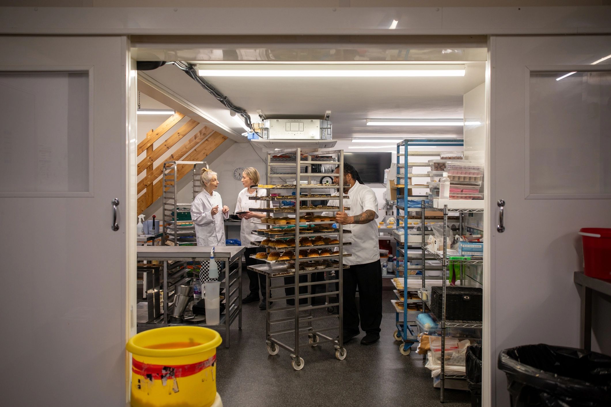Bakery staff reviewing stock and operations in a commercial kitchen